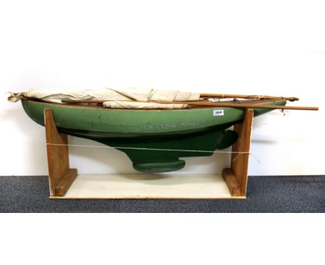 A large vintage wooden model pond yacht with stand, L. 105cm.