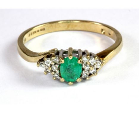 A 9ct yellow and white gold emerald and diamond set ring (P.5).