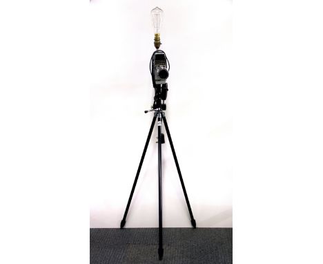 An interesting standard lamp created from a vintage movie camera mounted onto a tripod, H. 118cm.