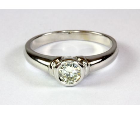 An 18ct white gold (worn stamp 18ct) diamond solitaire ring (J.5).