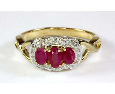 A 9ct yellow and white gold ruby and diamond set ring (P).