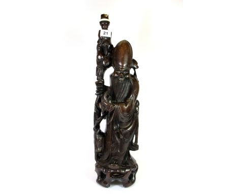 A large early 20th century Chinese carved hardwood figure of Shou Lao, mounted as a table lamp, H. 59cm.