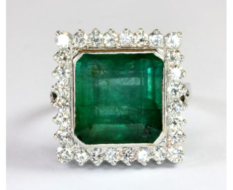 A stunning 14ct white gold (stamped 585) ring set with a 10.20ct square cut emerald surrounded by brilliant cut diamonds (ove