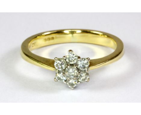 An 18ct yellow and white gold diamond cluster ring (L.5).