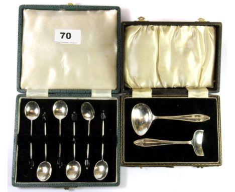 A boxed set of hallmarked silver coffee bean spoons and a child's hallmarked silver spoon and pusher.