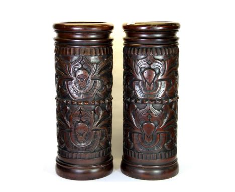 A pair of carved hardwood walking stick stands, H. 83cm.