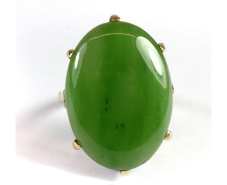 A 9ct yellow gold ring set with a large cabochon cut nephrite (2.5 x 1.8cm) (M).
