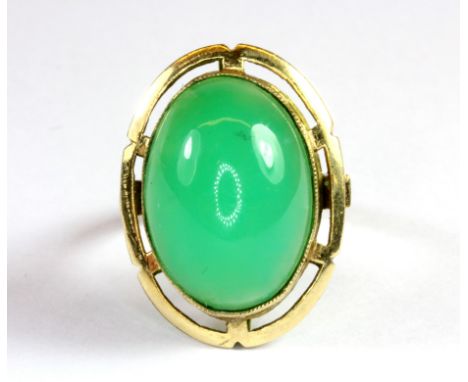 A 14ct yellow gold (stamped 14k) ring set with apple green jade (M).