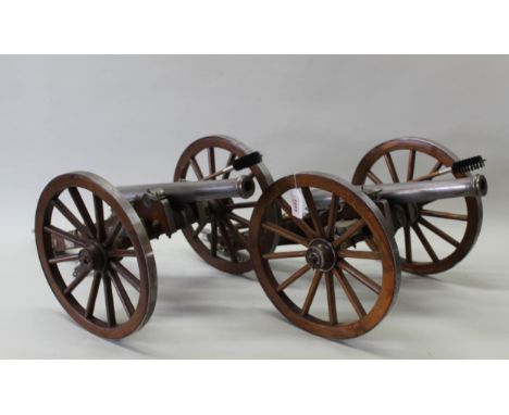 A pair of approx 1/4 scale model 'field guns', barrels approx 15" with the wheel diameter of 12" (some accessories missing)