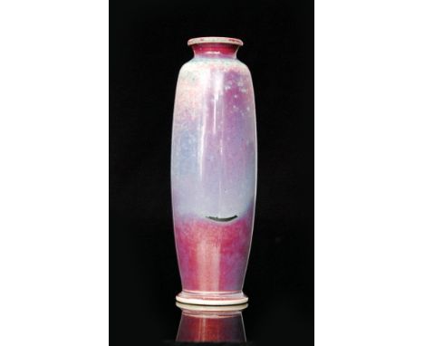 Ruskin Pottery - A high fired vase of rolling pin form decorated with a sang de beouf glaze with lavender patching and copper