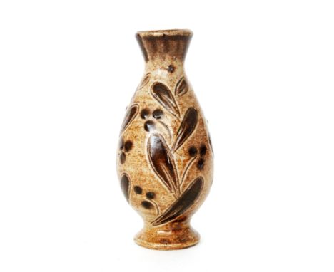 Martin Brothers - A small footed baluster vase decorated with incised mistletoe leaves and berries in brown against a lighter