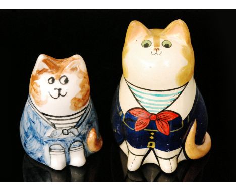 Joan de Bethel - A pair of hand painted models of cats, the first dressed in a blue jacket with striped shirt and red bow tie