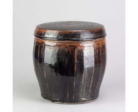 BERNARD LEACH (1887-1979) for Leach Pottery; a large stoneware cut sided jar and cover covered in tenmoku breaking to kaki gl