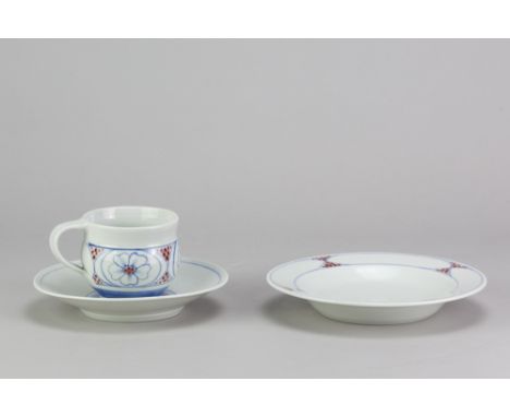 DEREK EMMS (1929-2004); a porcelain trio comprising cup, saucer and plate covered in celadon glaze with cobalt and copper red