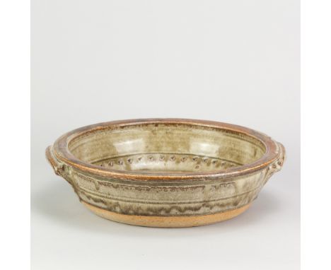 RICHARD BATTERHAM (1936-2021); a large stoneware lugged pan covered in green ash glaze with kaki rim and chatter marks to int