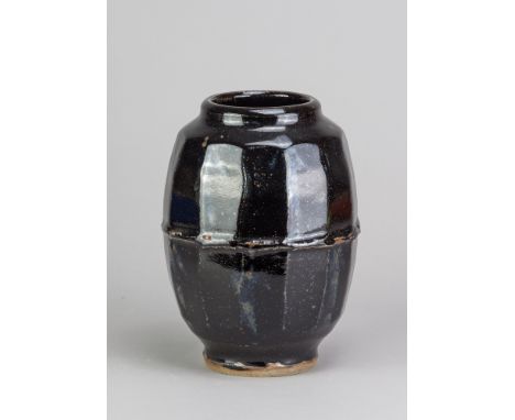 JIM MALONE (born 1946); a stoneware faceted jar covered in tenmoku breaking to kaki glaze, impressed JM and B (for Burnby) ma