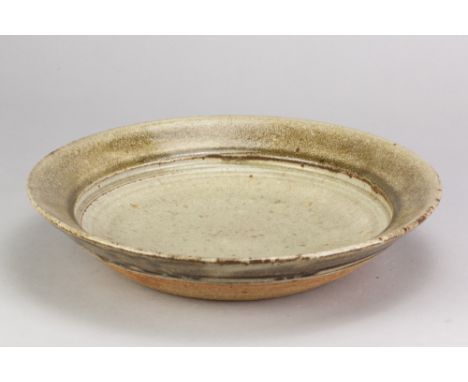 RICHARD BATTERHAM (1936-2021); a large stoneware dish covered in green ash glaze, diameter 30.5cm. (D)Additional InformationA