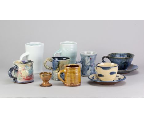 A group of mugs, cups and saucers and an egg cup by different makers including Matthew Blakely, Jane Hamlyn, David Constantin