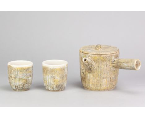LISE HERUD BRATEN; a stoneware fluted teapot covered in patchy green ash glaze, inscribed LHB mark, height 13.5cm, and a pair