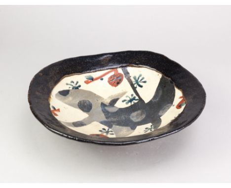 JOHN MALTBY (1936-2020); an stoneware oval footed dish decorated with two stylised birds flying over trees, painted signature