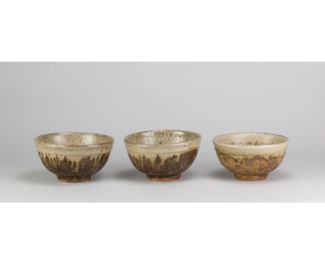 JIM MALONE (born 1946); a trio of stoneware bowls covered in green ash glaze with incised decoration, impressed JM and A (for