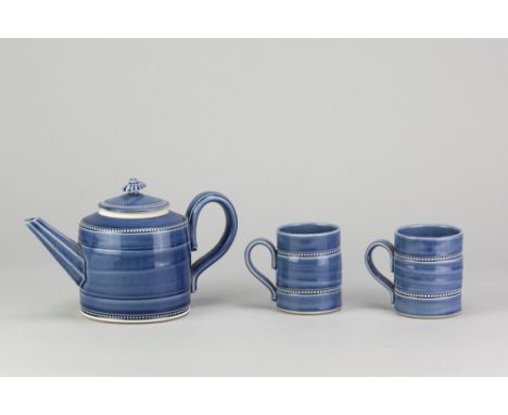 JOHN WHEELDON (born 1950); a porcelain teapot covered in blue glaze, impressed W mark, height 13cm, and a pair of matching mu