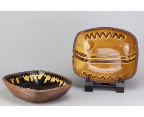 Winchcombe Pottery; two press moulded rectangular slipware dishes with pie crust rims, impressed early pottery marks, largest