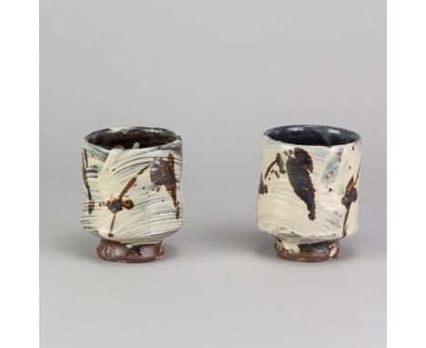 JIM MALONE (born 1946); a pair of stoneware yunomi covered in brushed slip with iron decoration, impressed JM and L (for Less