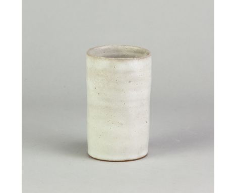 LUCIE RIE (1902-1995); a stoneware beaker covered in pitted white glaze, impressed LR mark, height 11.5cm. (D)Additional Info