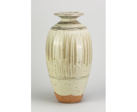 RICHARD BATTERHAM (1936-2021); a tall stoneware fluted bottle covered in green ash glaze, made circa 1993, height 37cm. (D)Ad