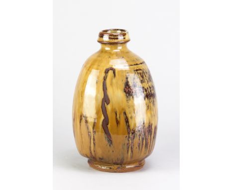 MIKE DODD (born 1943); a stoneware cut sided bottle covered in river iron mustard glaze with wax resist decoration, impressed