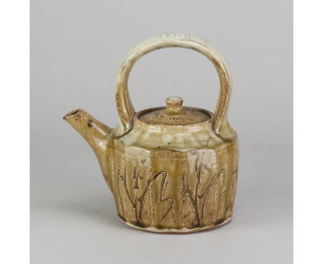 JIM MALONE (born 1946); a stoneware faceted teapot with loop handle covered in green ash glaze with incised decoration and nu