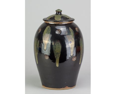 JIM MALONE (born 1946); a stoneware jar and cover covered in tenmoku breaking to kaki glaze with impressed decoration and cop