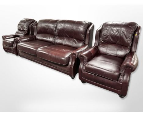 A Wade three-piece stitched Burgundy leather lounge suite, comprising of a three-seater settee, length 204cm, and a pair of a