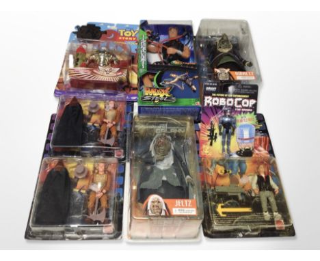 A group of Mattel and other figurines, including Last Action Hero, The Hitchhiker's Guide to the Galaxy, Toy Story, etc., box