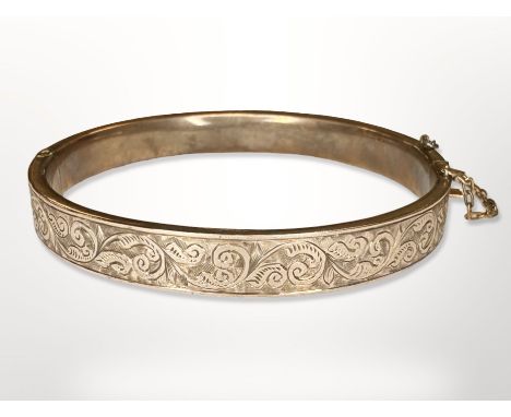 An antique engraved gold hinged bangle, apparently unmarked, inner diameter 5.5cm CONDITION REPORT: 10.4g