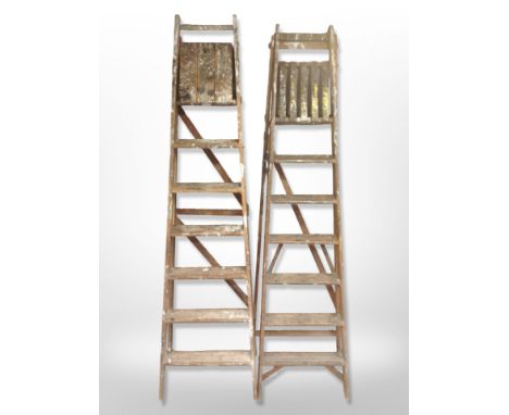 Two vintage wooden step ladders.