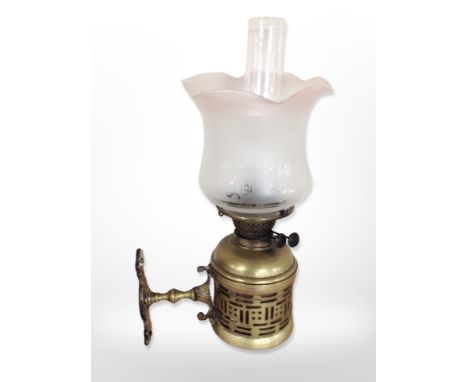 A brass Duplex wall-mounted oil lamp with frosted and etched shade and clear chimney, depth from wall 25cm.