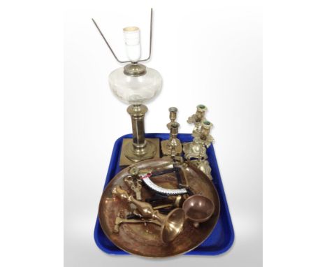 Two pairs of brass candlesticks, a brass oil lamp (converted), charger, brass candle snuffer and toffee hammer, etc.
