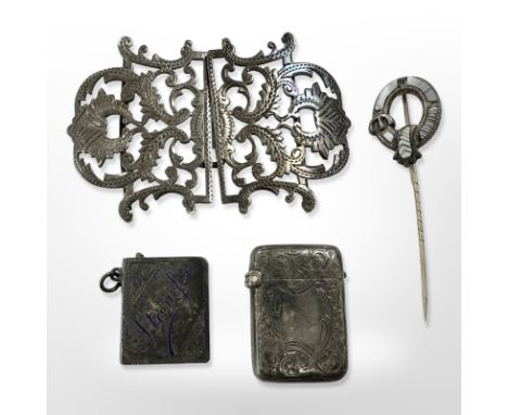 A silver belt buckle, agate-set stick pin, a silver vesta and a stamp case with enamelled decoration 