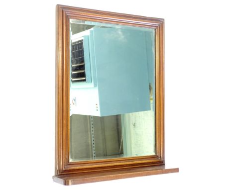 A mahogany dressing mirror, with a moulded frame, bevelled rectangular plate, above a shelf or platform, 73cm high, 55cm wide