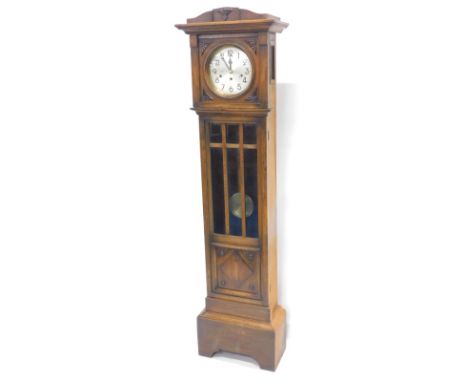 An early 20thC oak cased longcase clock, the silvered dial with Arabic numerals and brass bezel, Westminster chime day moveme