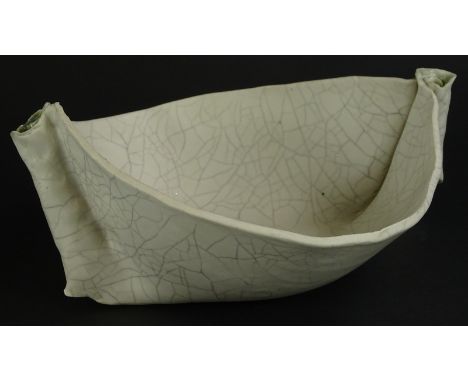 A Polish Art Pottery cream glazed ceramic two handled dish, with crackle glaze embellished with roundels etc., impress mark a