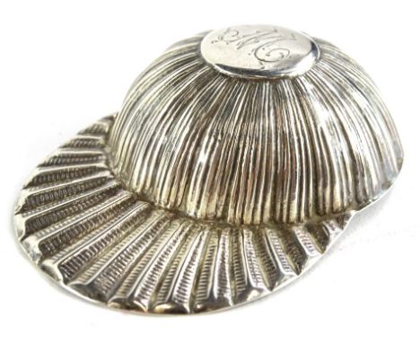 A Victorian silver caddy spoon, modelled in the form of a jockey's cap, bearing the initial M, marks indistinct.