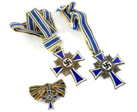 Three German Third Reich Mothers Cross medals, a silver large and miniature medal, and a bronze, each dated 16th December 193