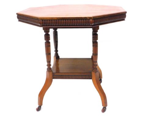 An Edwardian octagonal window table, with a fluted edge, on turn supports with square undertier and splayed legs, terminating