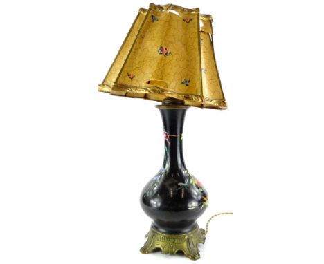 A Paris porcelain lamp base, painted with flowers, on a black ground, with gilt metal mounts and paper and gesso shade, shade