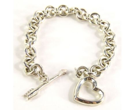 A silver heart and arrow bracelet, marked Italy Tiffany &amp; Co 1984, 22cm long overall, in Bergerie box.&nbsp;