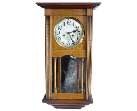 A mahogany cased wall clock, the silvered dial with Arabic numerals, 70cm high.