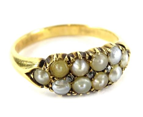 A pearl and diamond set gypsy ring, set with ten cultured pearls of varying colour, from cream to silver, and three tiny roun